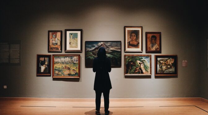A person admiring art in an art gallery
